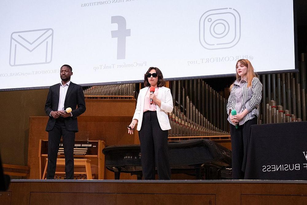 Three WWU students present their pitch on stage